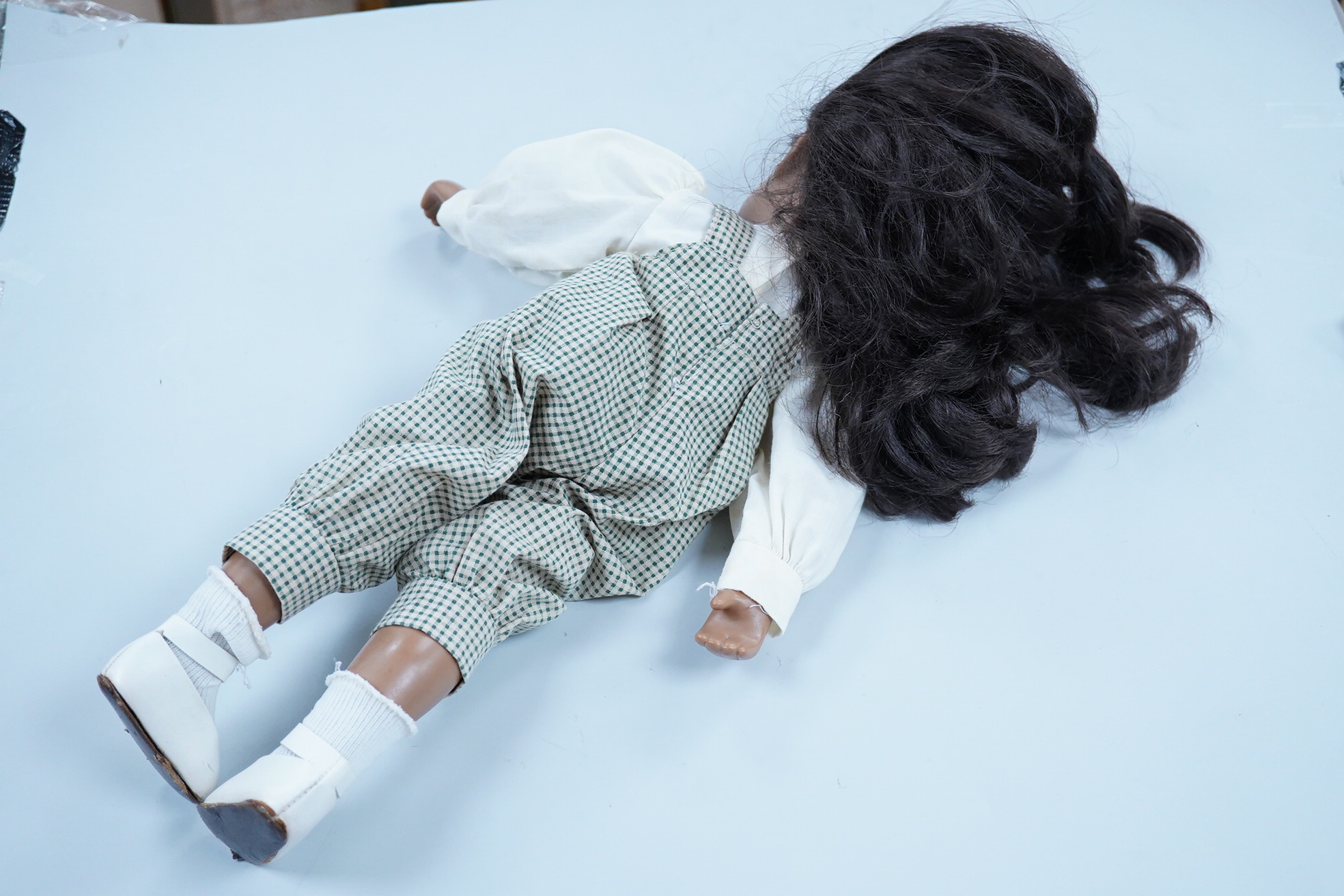 A Sasha Doll, 42cm high, with a selection of clothes, including some possible original commercially produced clothes together with other handmade clothes